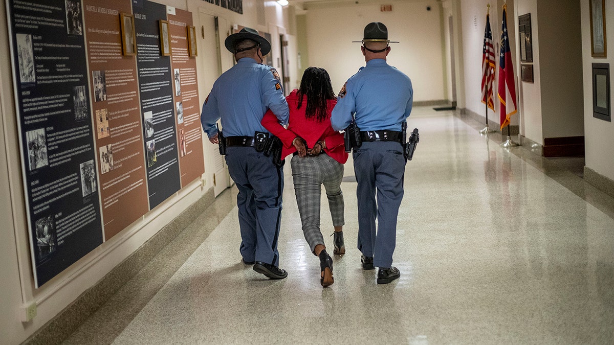 Rep. Park Cannon, D-Atlanta, is escorted out of the Georgia Capitol Building by Georgia State Troopers at the Georgia State Capitol Building in Atlanta, Thursday, March 25, 2021. (Associated Press)