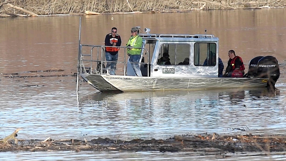 In this Wednesday, Dec. 4, 2019, photo, Missouri law enforcement personnel aided by the United State Geological Survey team use imaging sonar to try to locate the body of Mengqi Ji Elledge near Columbia, Mo. (Don Shrubshell/Columbia Daily TribuneTribune via AP)