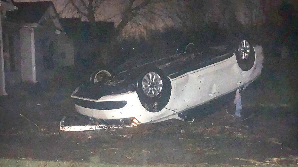 A vehicle flipped on its roof and covered in debris after a tornado touched down in Newnan, Georgia, early Friday March 26, 2021. (@@charityislove via AP)