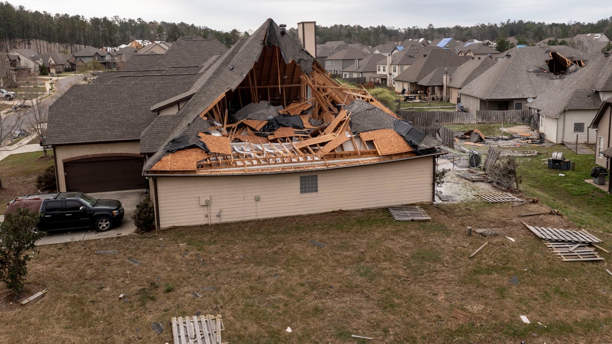 In this image taken with a drone, many homes with damaged roofs, Friday, March 26, 2021, in the Timberline subdivision in Calera, Ala., the day after a severe storm swept through the area. (AP Photo/Vasha Hunt)