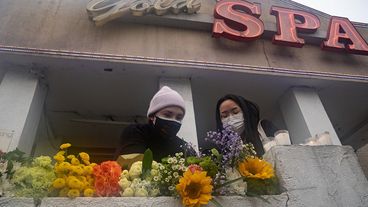 Mourners visit and leave flowers at the site of two shootings at spas across the street from one another, in memorial for the lives lost, on March 17, 2021 in Atlanta, Georgia. (Megan Varner/Getty Images)