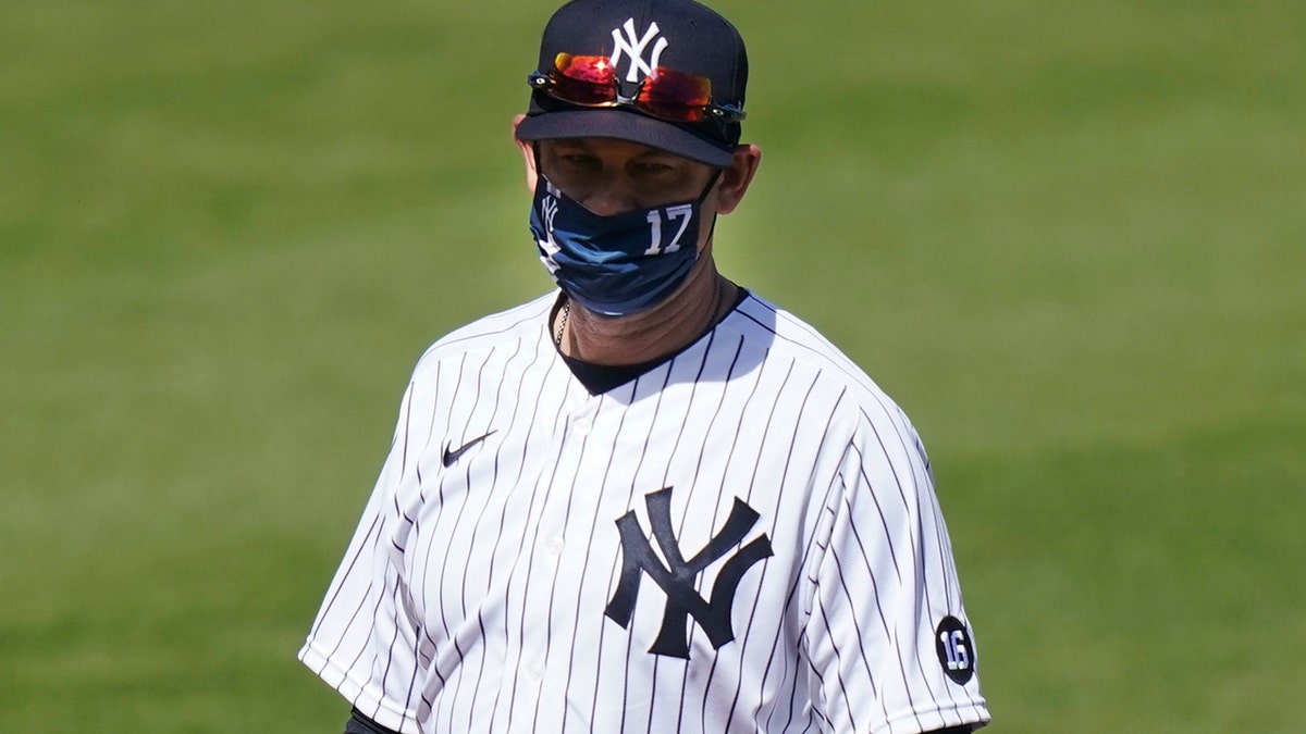 New York Yankees' Manager Aaron Boone stands on the field before a spring baseball game against the Toronto Blue Jays Sunday, Feb. 28, 2021, in Tampa, Fla.