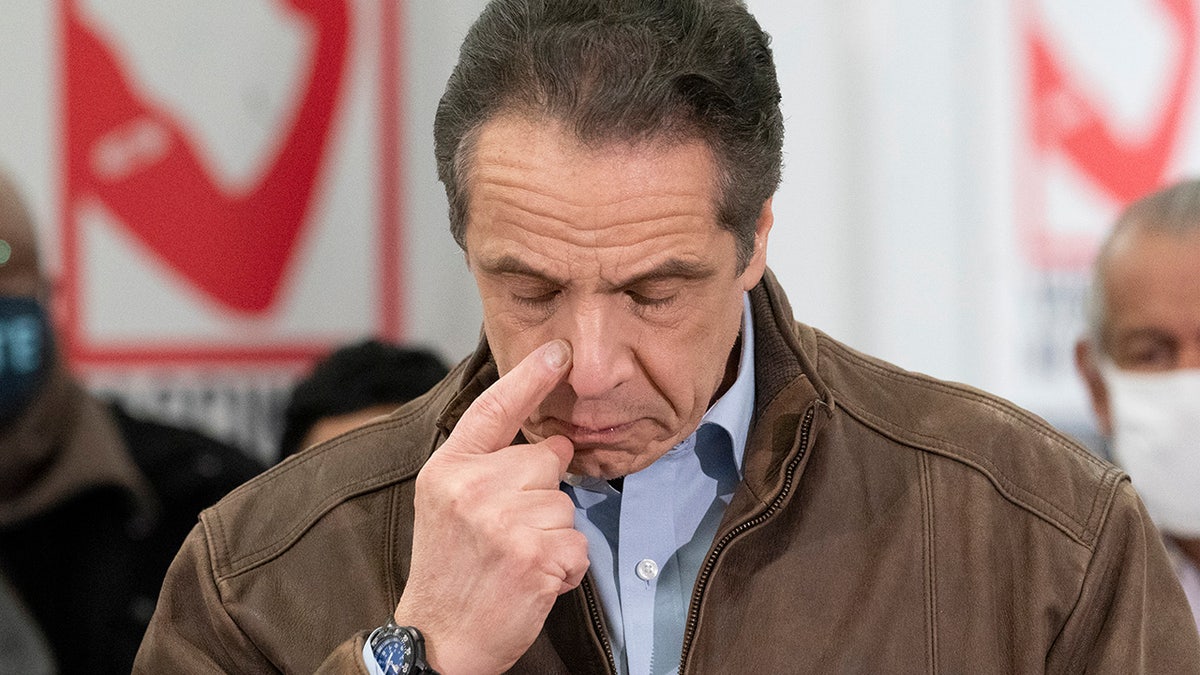 New York Gov. Andrew Cuomo touches his nose during a visit to a new COVID-19 vaccination site, Monday, March 15, 2021, at the State University of New York in Old Westbury. (AP Photo/Mark Lennihan, Pool)