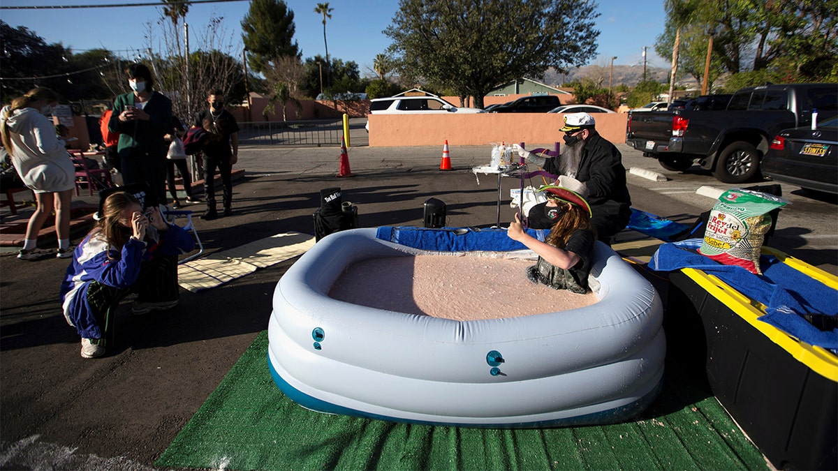 Barker sat in the tub of bean dip in front of Los Toros for 24 hours on Monday to raise awareness for the restaurant as it struggles during the coronavirus pandemic.