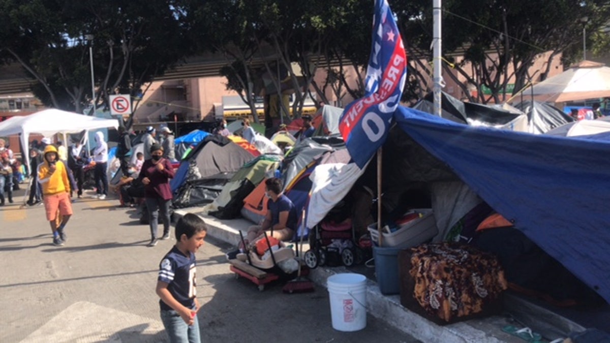 A Joe Biden campaign flag flies at a migrant camp near the U.S southern border. Republicans blame Biden's campaign rhetoric and policies for fueling the surge at the border. (Griff Jenkins/Fox News)