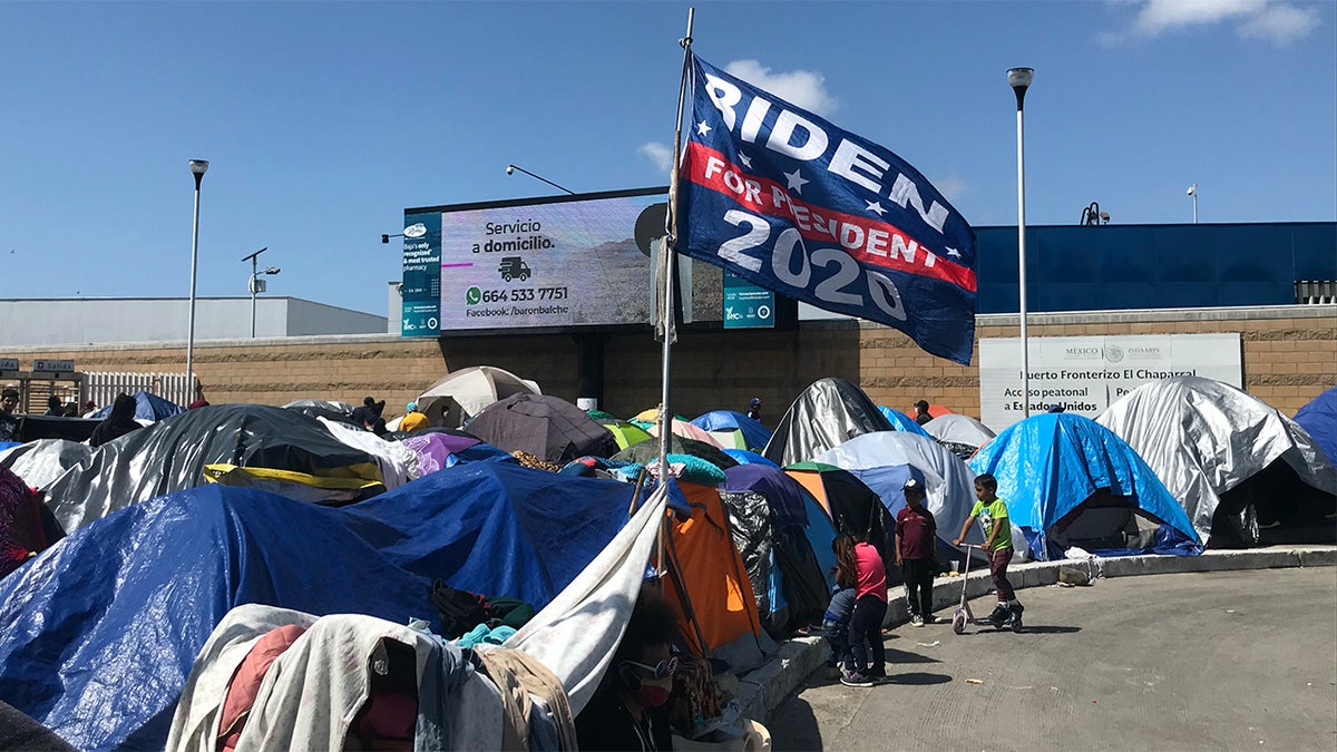 A Biden campaign flag at a migrants camp where asylum seekers wait for U.S. authorities to allow them to start their migration process outside El Chaparral crossing port in Tijuana, Baja California state, Mexico on March 21, 2021.