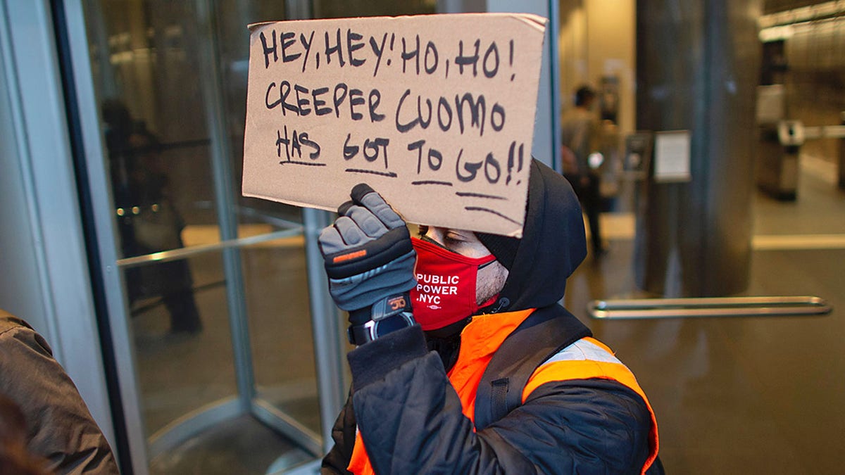 People attend a protest to demand New York Governor Andrew Cuomo's resignation after a third woman accused him of sexual harassment in New York City on March 2, 2021. - New York Governor Andrew Cuomo was fighting for his political life on March 2, 2021, after a third woman accused him of sexual harassment. The Democrat has suffered a spectacular fall from grace since he became a national star last year for his handling of the state's coronavirus pandemic. (Photo by Kena Betancur / AFP) (Photo by KENA BETANCUR/Afp/AFP via Getty Images)