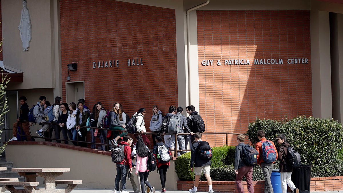 Students walk between buildings at St. Francis High School Friday, March 3, 2017, in Mountain View, Calif. 