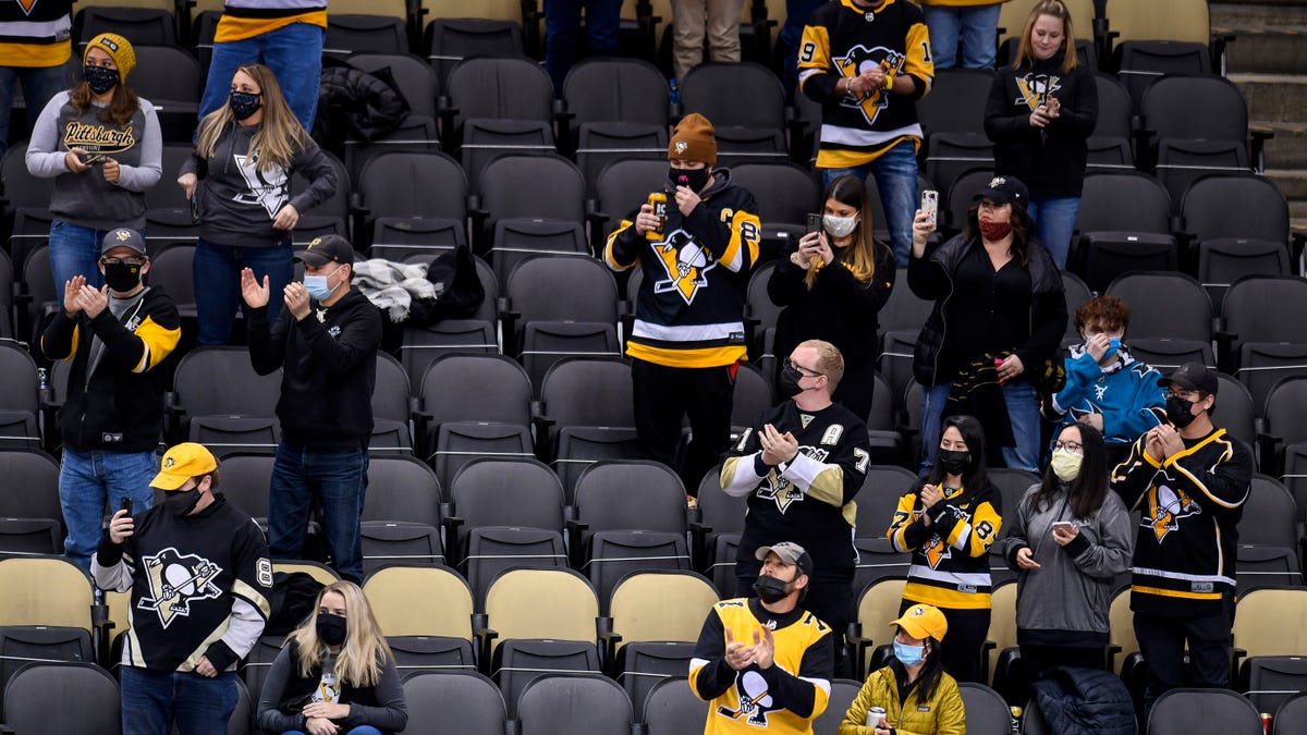 PITTSBURGH, PA - MARCH 02: Social distant fans cheer during the first period in the NHL game between the Pittsburgh Penguins and the Philadelphia Flyers on March 2, 2021, at PPG Paints Arena in Pittsburgh, PA. (Photo by Jeanine Leech/Icon Sportswire via Getty Images)
