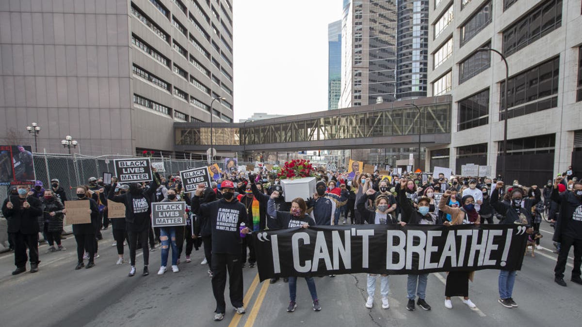 MINNEAPOLIS, MINNESOTA, USA - MARCH 7: Protesters march through the city during a silent march in memory of George Floyd a day before jury selection for the trial of former Minneapolis police offices Derek Chauvin begins in Minneapolis, Minnesota, United States on March 7, 2021. George was killed by former police officer Derek Chauvin in 2020. The trial for former officer Chauvin starts on Monday, March 8 with jury selection. (Photo by Christopher Mark Juhn/Anadolu Agency via Getty Images)