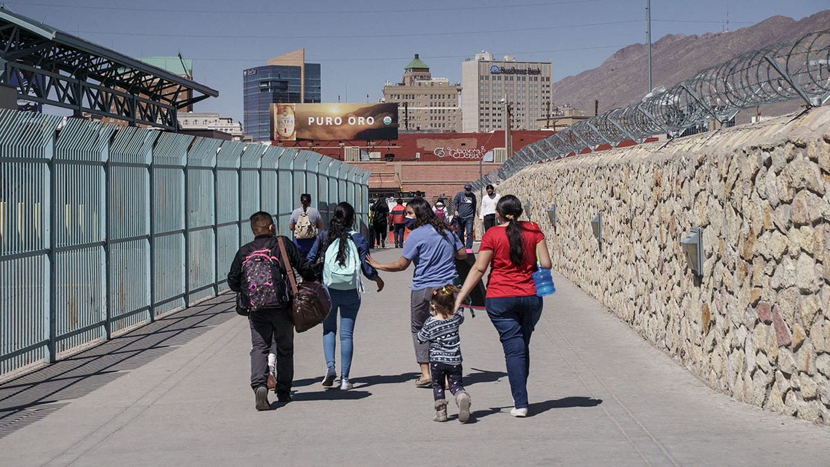 Migrants who had been in Mexico under the Migrant Protection Protocols, or the "Remain in Mexico" program, enter the United States at the Paso del Norte Bridge in El Paso, Texas on March 10, 2021. 