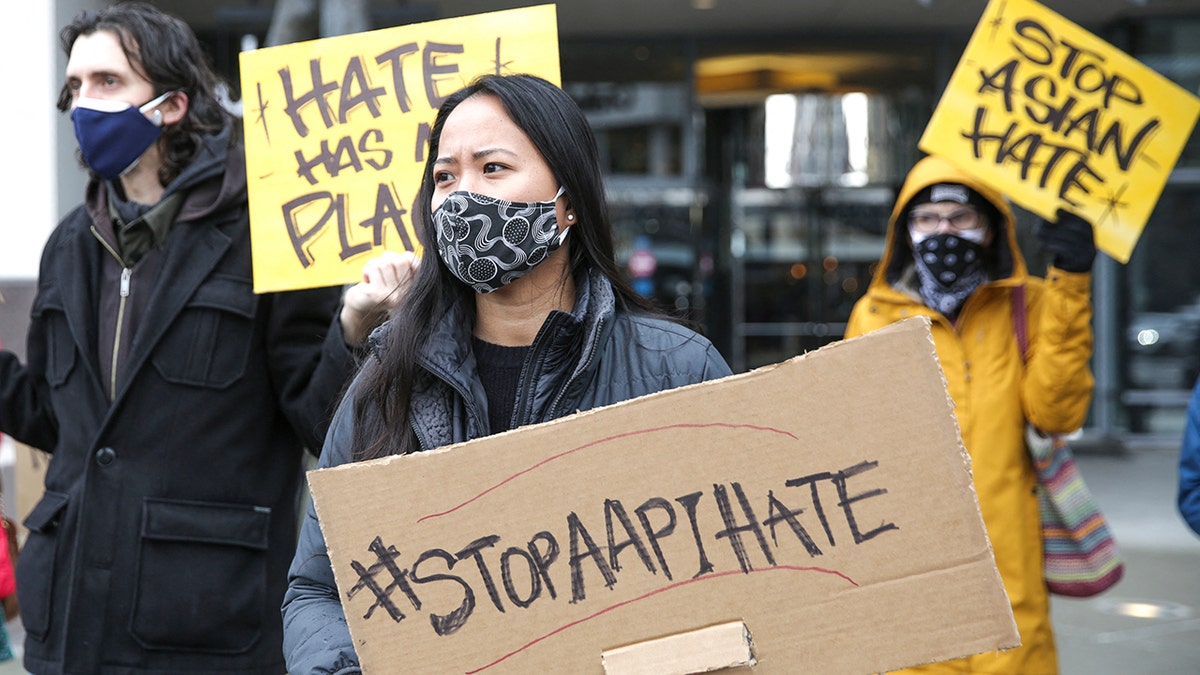 Woman holds a 'Stop Asian Hate sign' at a protest