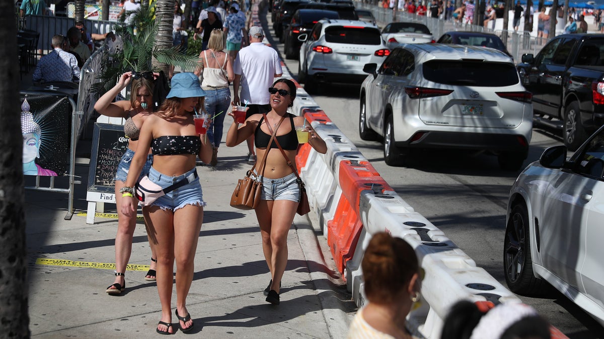 FORT LAUDERDALE, FLORIDA - MARCH 04: People walk near the beach on March 04, 2021 in Fort Lauderdale, Florida. College students have begun to arrive in the South Florida area for the annual spring break ritual. City officials are anticipating a large spring break crowd as the coronavirus pandemic continues. They are advising people to wear masks if they cannot social distance. (Photo by Joe Raedle/Getty Images)