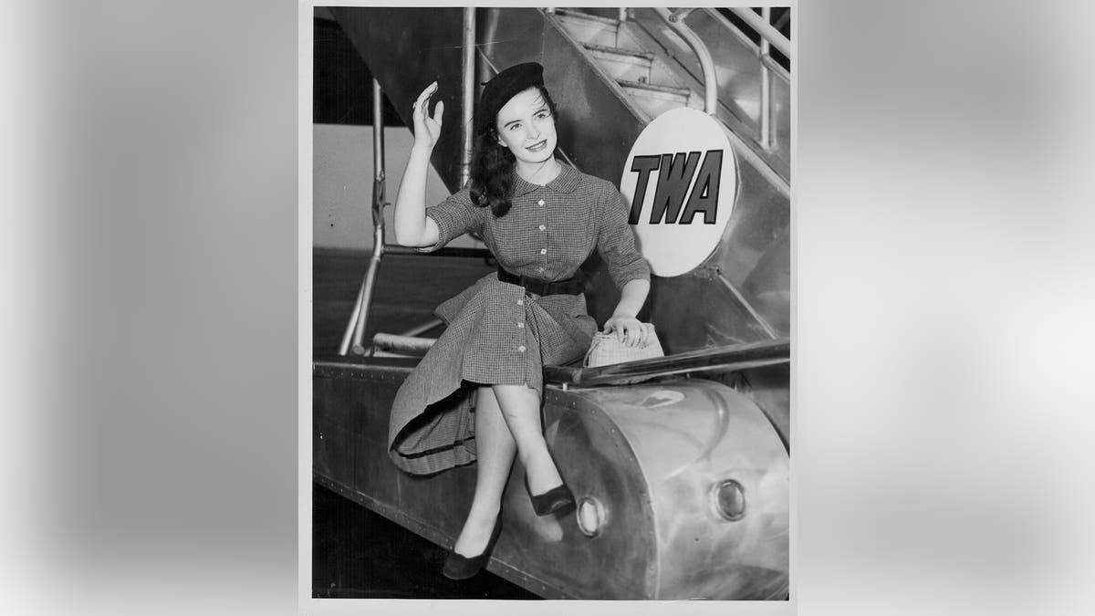 Actress Margaret O'Brien posing next to an airplane at Idlewild Airport, New York, circa 1951.