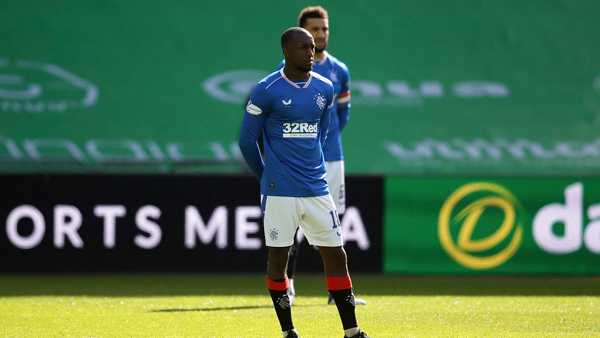 Rangers' Glen Kamara stands instead of taking a knee prior to the Scottish Premiership soccer match at Celtic Park, Glasgow, Sunday March 21, 2021. Glasgow's rival soccer teams stood rather than taking a knee in a pre-match solidarity before the derby at Celtic after Rangers midfielder Glen Kamara faced racial abuse in a European match. (Andrew Milligan/PA via AP)