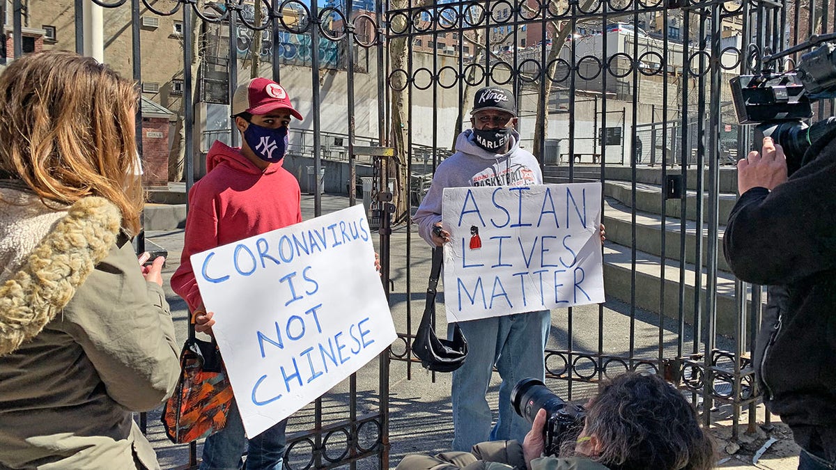 Asian Lives Matter at the scene the day after an Asian woman was attacked in New York City.