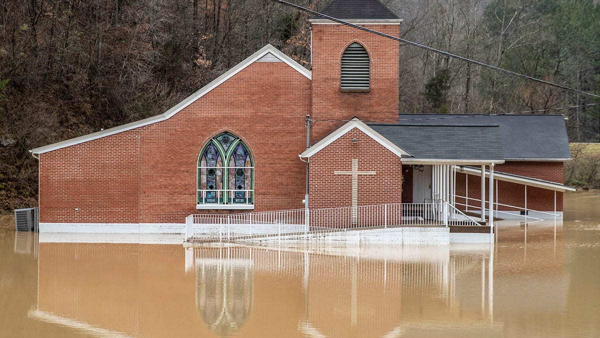 Flood waters surround Rockhouse Freewill Baptist Church in Johnson County, Ky., Monday, March 1, 2021. Heavy rain across Appalachia has led to water rescues, mudslides, road closures and power outages, officials said. (Ryan C. Hemens/Lexington Herald-Leader via AP)