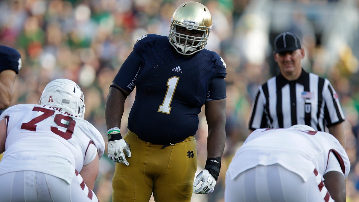 In this Saturday, Aug. 31, 2013, file photo, Notre Dame defensive lineman Louis Nix III (1) prepares to get into his defensive stance during the second half of an NCAA college football game against Temple in South Bend, Ind. (AP Photo/Michael Conroy, File)