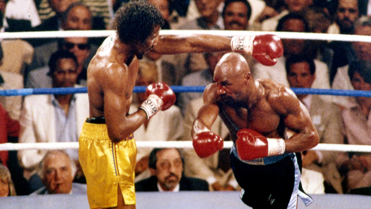 FILE - In this April 1985 file photo, Marvin Hagler, right, and Thomas Hearns fight during the first round of a world championship boxing bout in Las Vegas. Hagler, the middleweight boxing great whose title reign and career ended with a split-decision loss to "Sugar" Ray Leonard in 1987, died Saturday, March 13, 2021. He was 66. (AP Photo, File)