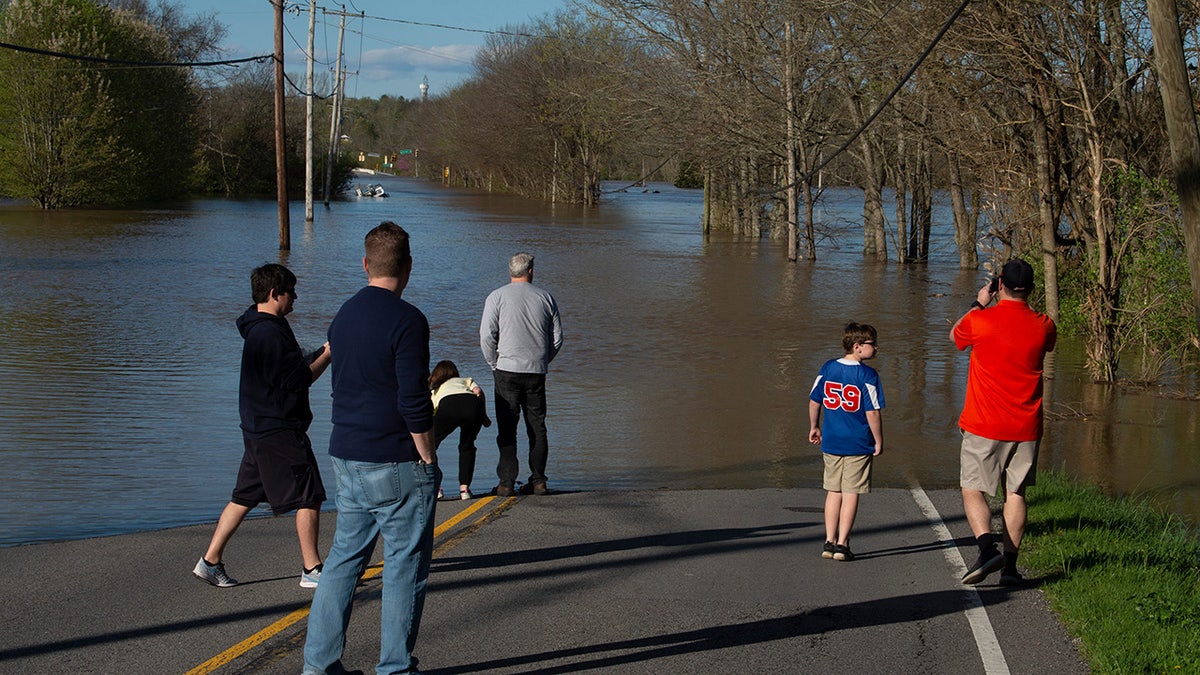 Bellevue residents survey flooding from the Harpeth River on Sunday in Nashville, Tenn. Flash flooding from storms the night before caused road closures in the Bellevue neighborhood. (Reuters)