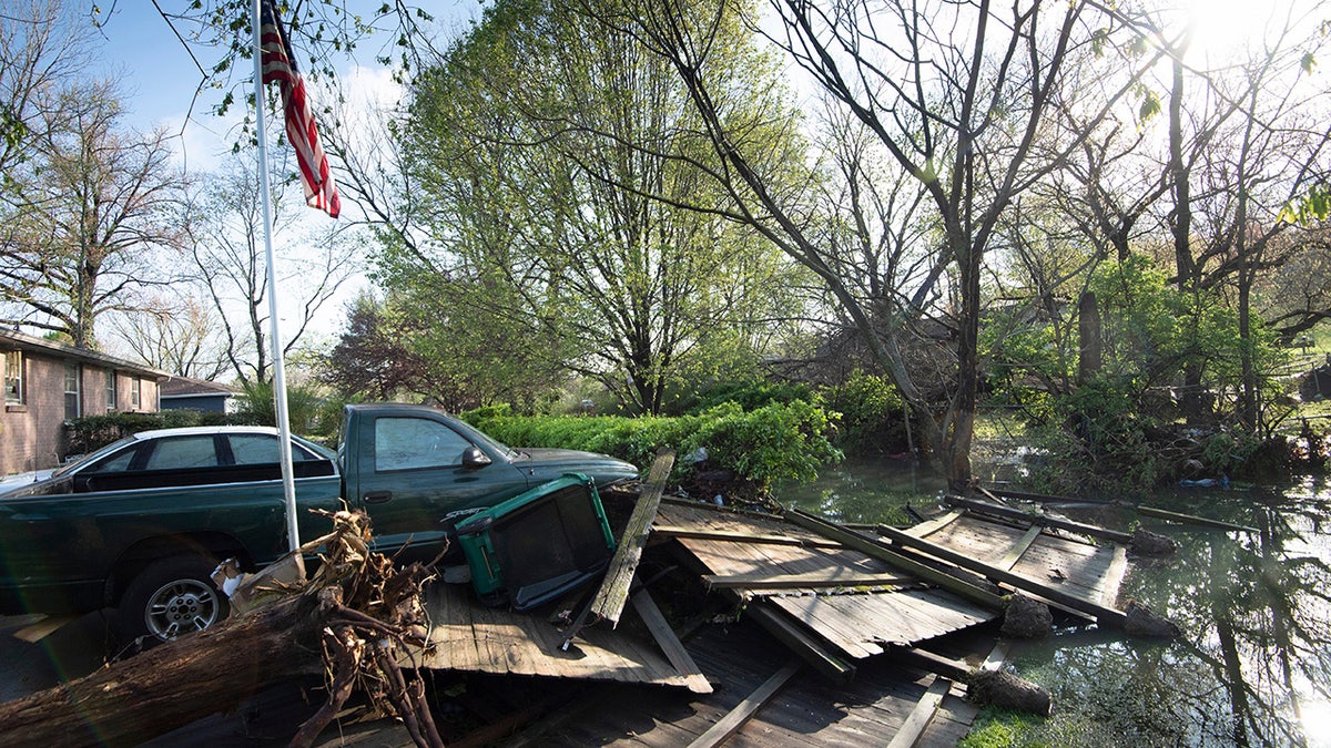 Debris lies in the backyard yard outside a home in Nashville on Sunday. Flash flooding along Sevenmile Creek the night before caused major damage in the South Nashville neighborhood. (Reuters)