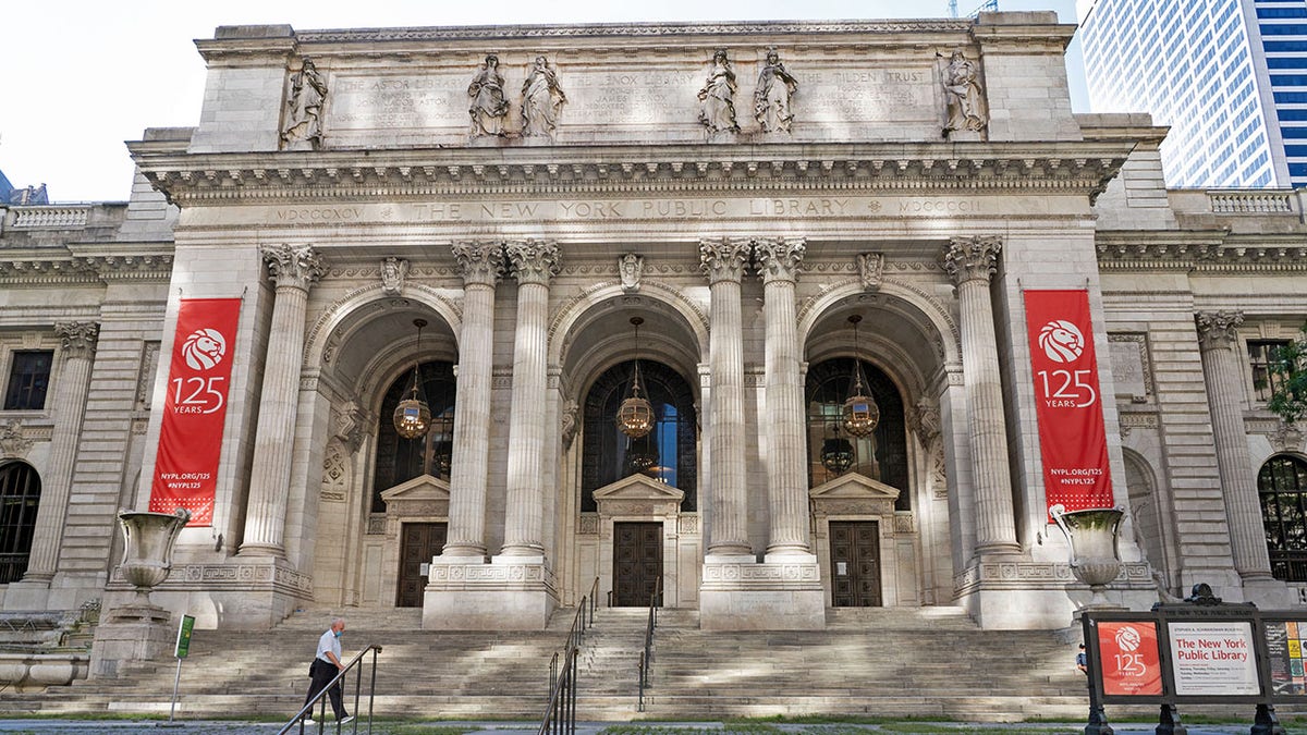 An exterior view of New York Public Library on Fifth Avenue in New York, in an image dated 7/13/2020. The New York Public Library's stone lions Patience and Fortitude have donned face masks to remind New Yorkers to wear face coverings during the COVID-19 pandemic. (Photo by Ron Adar/SOPA Images/LightRocket via Getty Images)