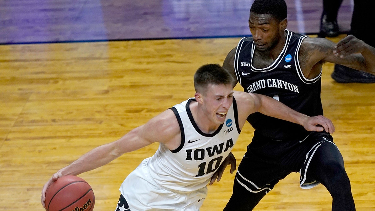 Iowa's Joe Wieskamp (10) guarded by Oscar Frayer in their tournament game Saturday, March 20, 2021, at the Indiana Farmers Coliseum in Indianapolis. (AP Photo/Charles Rex Arbogast)