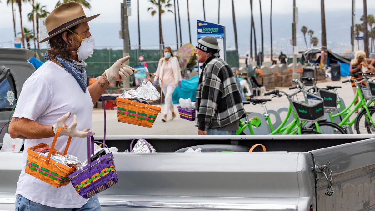 Celebrity men's groomer Jason Schneidman giving out Easter baskets full of supplies to the homeless in Venice, California.