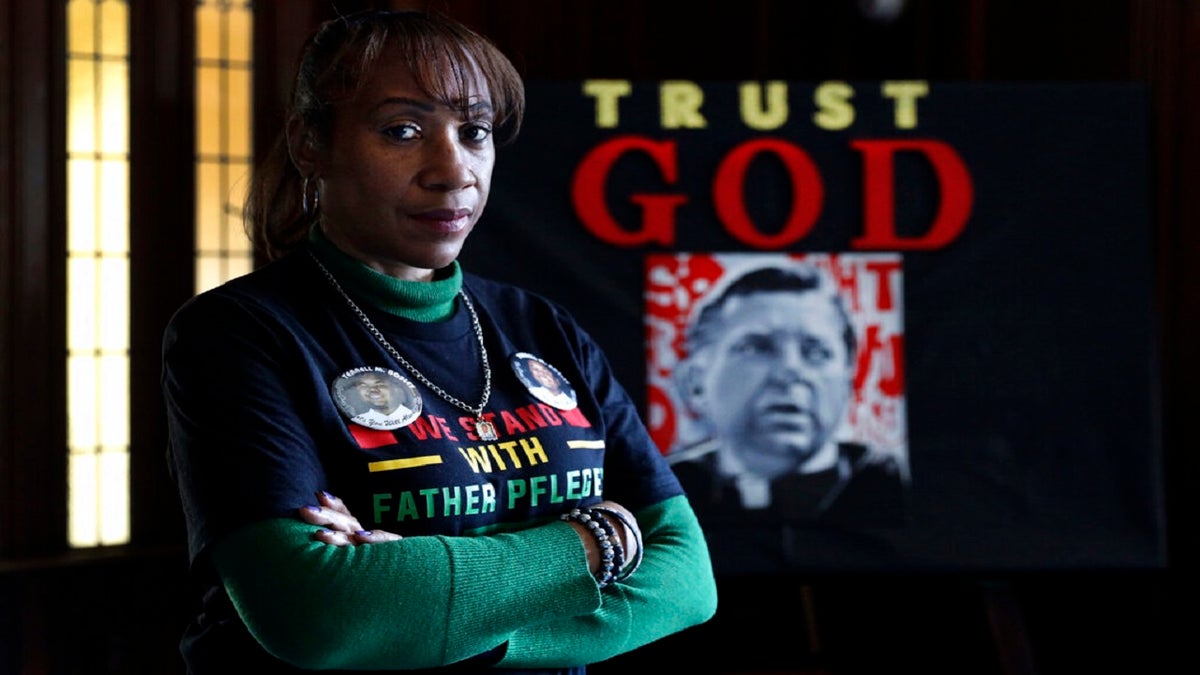Activist Pam Bosley poses for a portrait infront of a portraiture of Father Michael Pfleger, inside the St. Sabina Catholic Church on March 4. (AP)