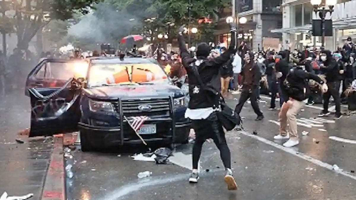 Kelly Thomas Jackson, 20, allegedly threw Molotov cocktails at two Seattle police vehicles during a May 30 protests that devolved into a riot.