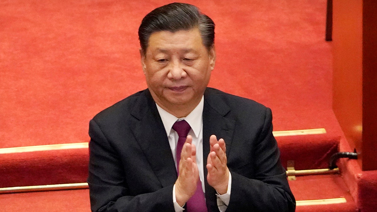 Chinese President Xi Jinping applauds during the closing session of the Chinese People's Political Consultative Conference (CPPCC) at the Great Hall of the People in Beijing, Wednesday, March 10, 2021.