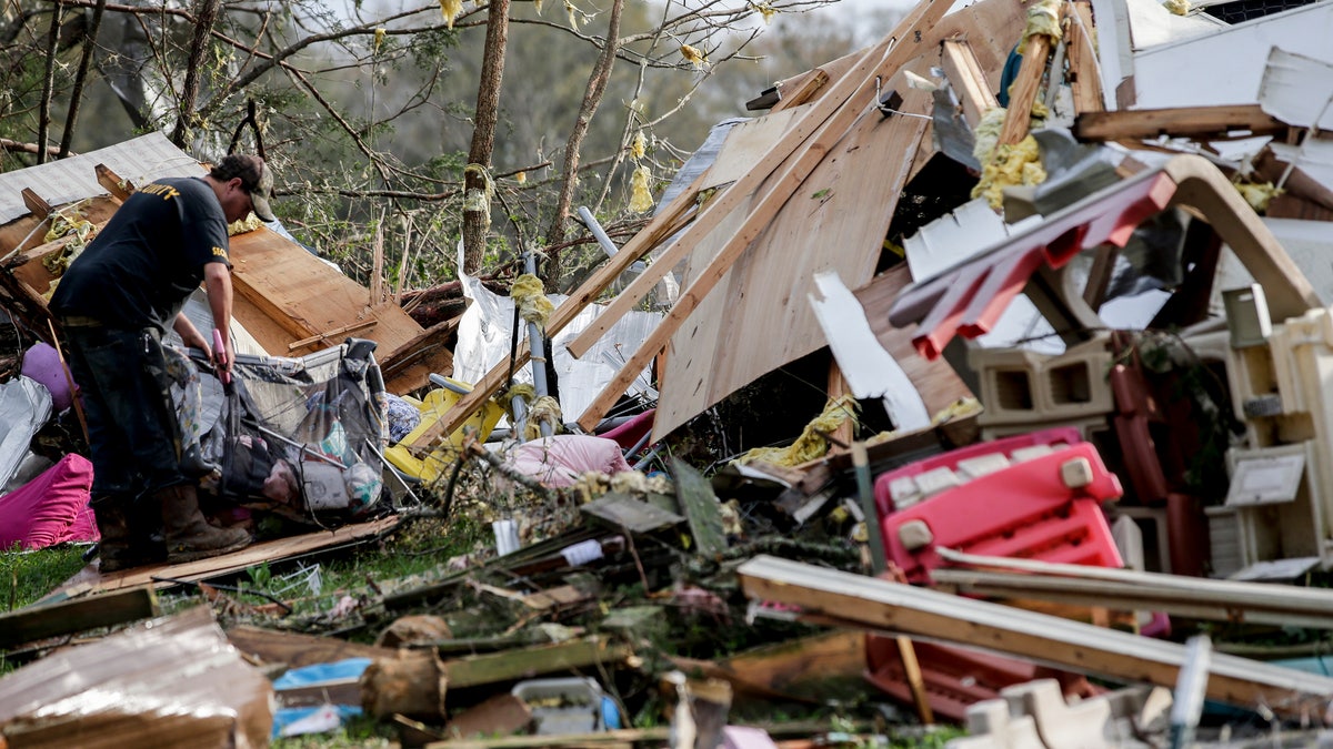 Residents begin the clean up process after a tornado touched down Friday, March 26, 2021 in Wellington, Ala. A tornado outbreak has ripped across the Deep South leaving paths of destruction. (AP Photo/Butch Dill)