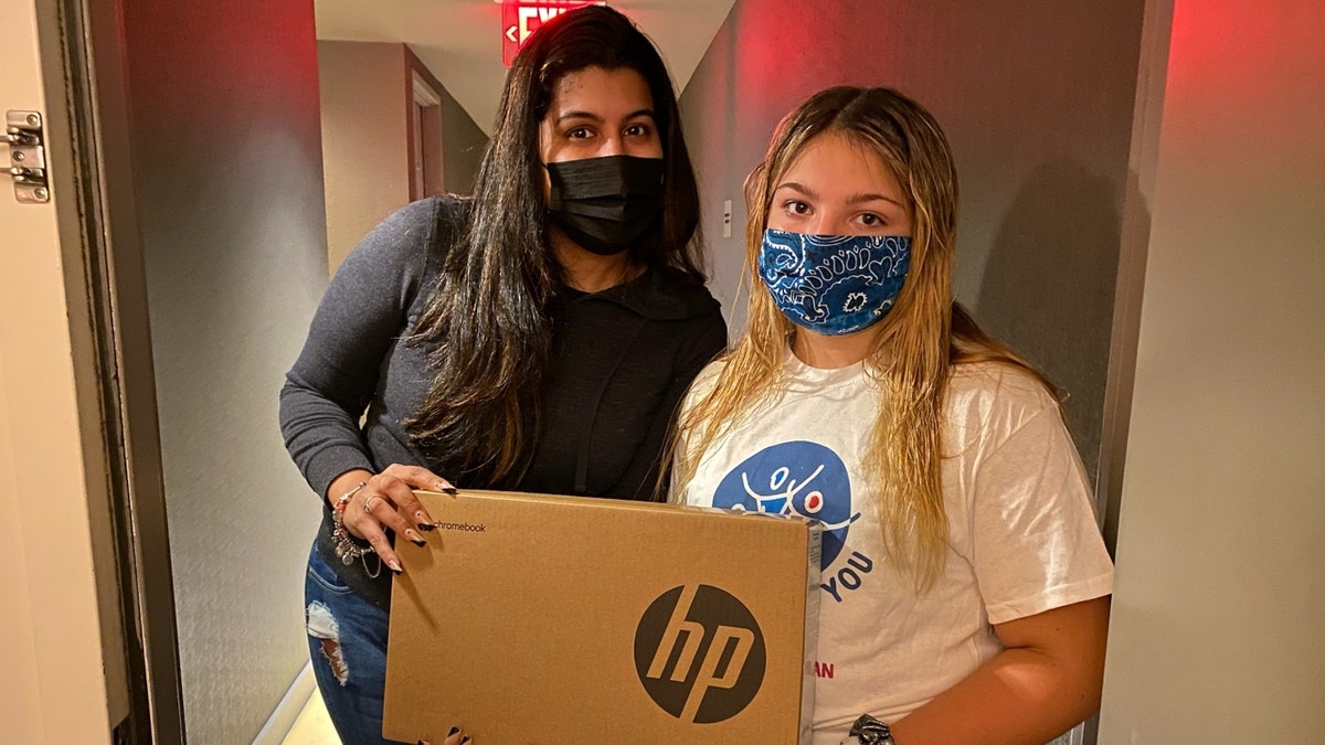 Daisy Hampton collecting laptop donations (Credit: Jen Hampton)