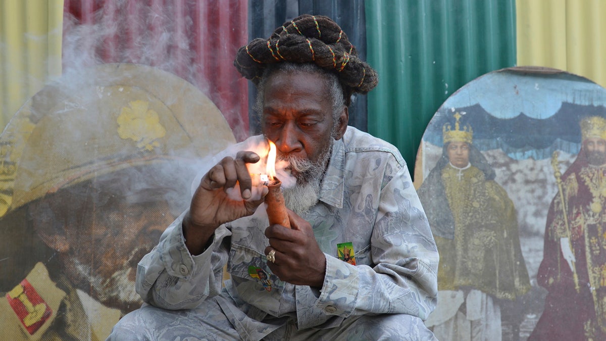  Bunny Wailer smokes a pipe stuffed with marijuana during a "reasoning" session in a yard in Kingston, Jamaica. Wailer, who was the last surviving member of the legendary group The Wailers, died on Tuesday, March 2, in his native Jamaica, according to his manager.