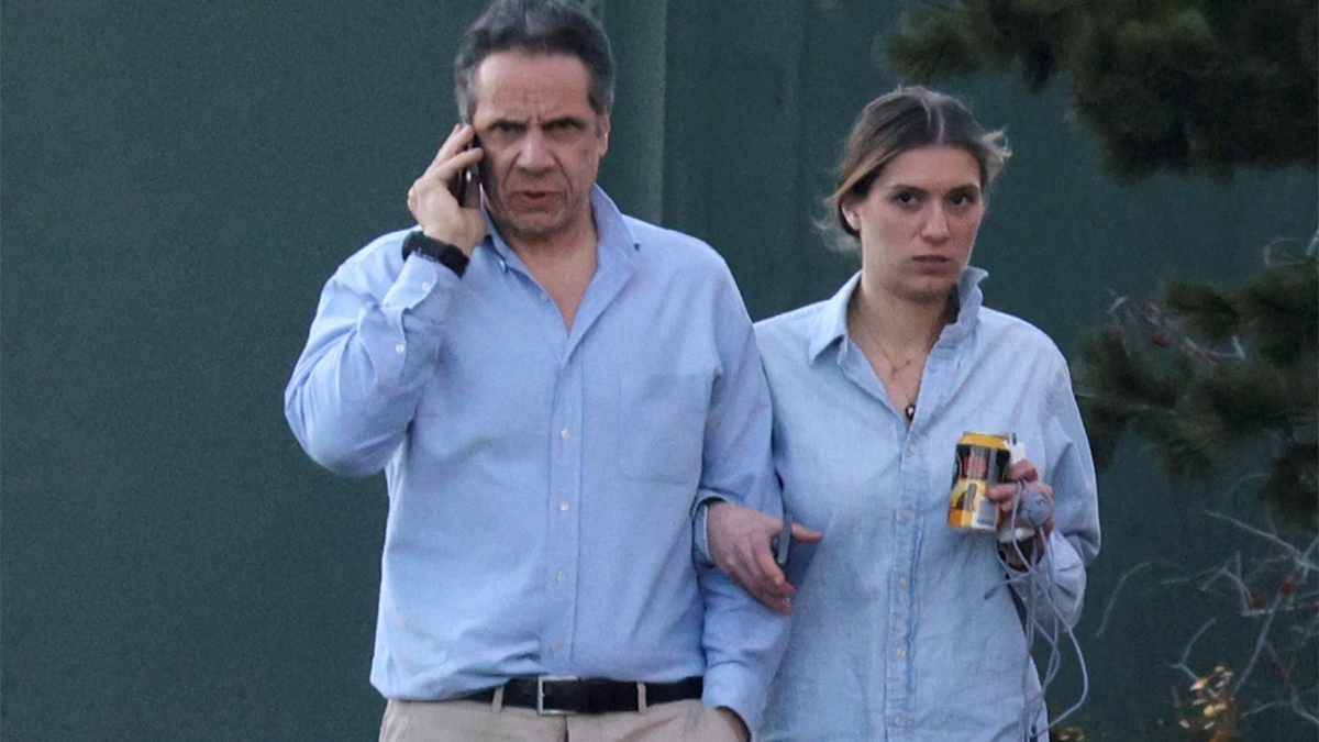 Gov. Andrew Cuomo, walks with daughter Mariah Kennedy-Cuomo on the grounds of the Governor's Mansion on March 12, 2021. Cuomo's campaign is alleged to have helped boost sales of the governor's book by sending at least one note to his email list which was signed in the names of Cuomo's children. 