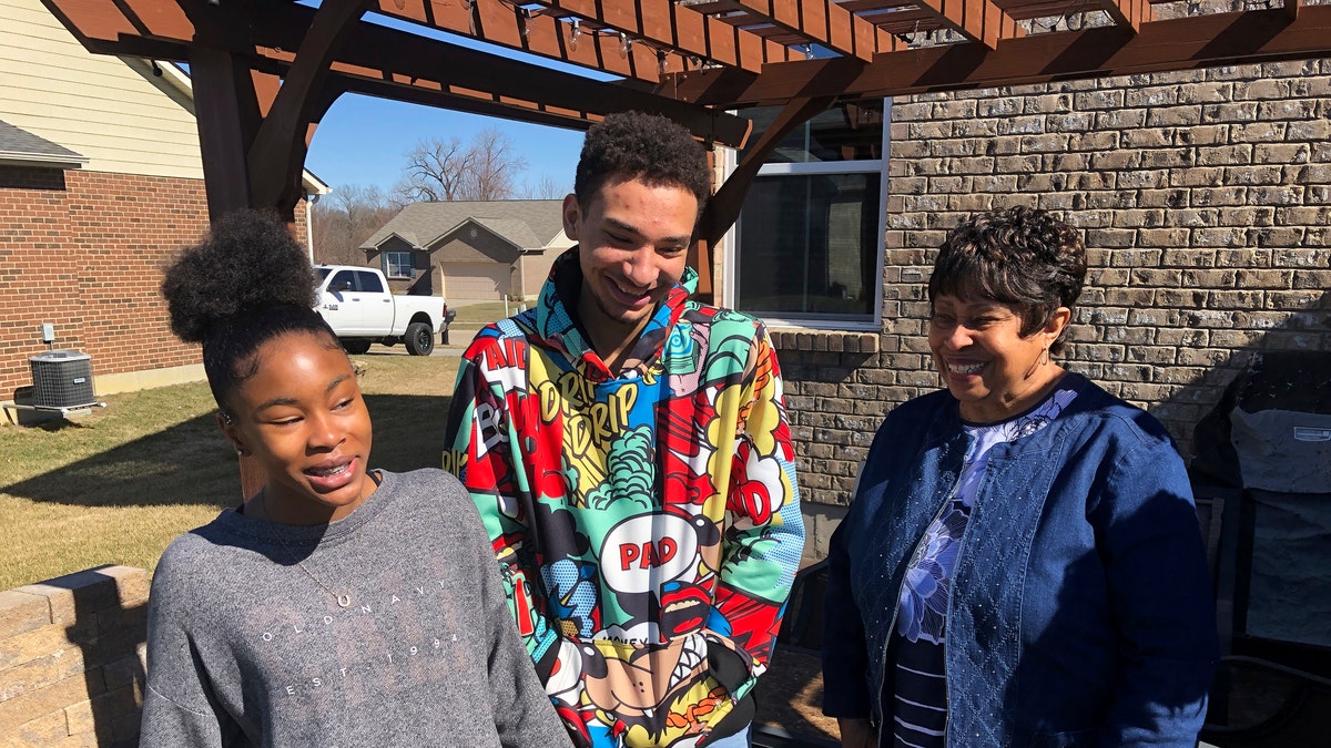 March 7, 2021: Brilee Carter, left,13, and Cobe Calhoun, 17, share a laugh with their great-grandmother, Doris Rolark, outside Rolark's daughter's home in Monroe, Ohio. 