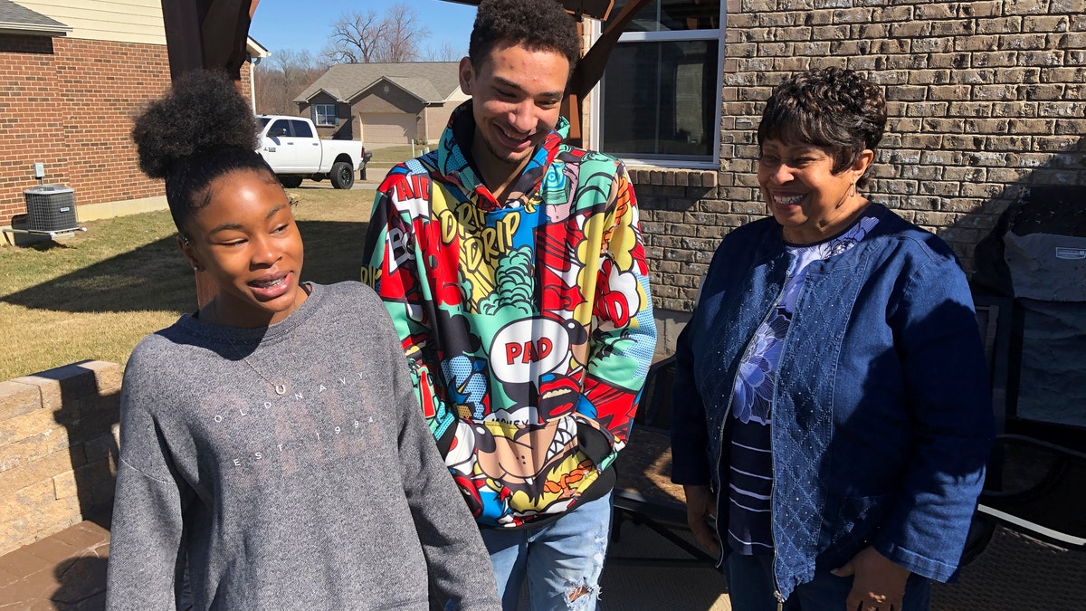 March 7, 2021: Brilee Carter, left,13, and Cobe Calhoun, 17, share a laugh with their great-grandmother, Doris Rolark, outside Rolark's daughter's home in Monroe, Ohio.