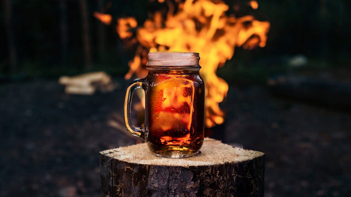 Mug Of Beer Near Roaring Bonfire Flames