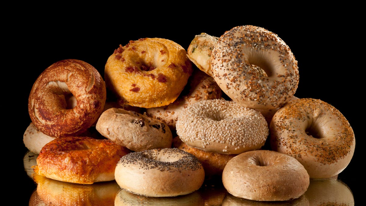 Assorted bagels stacked.