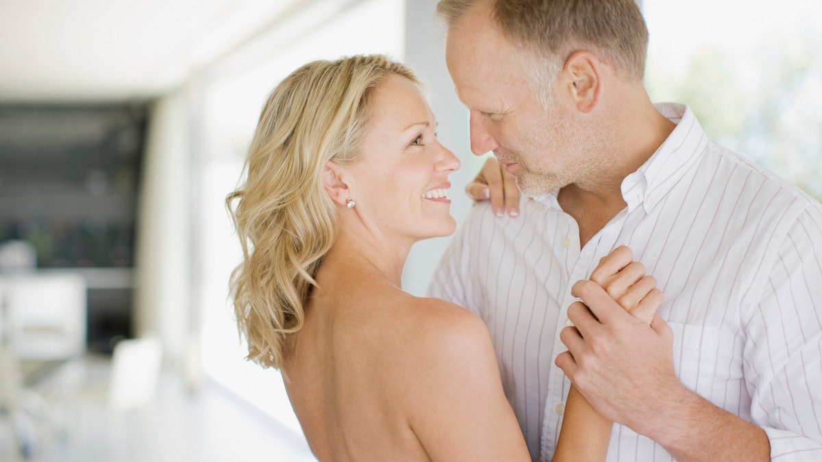 Couple dancing in living room