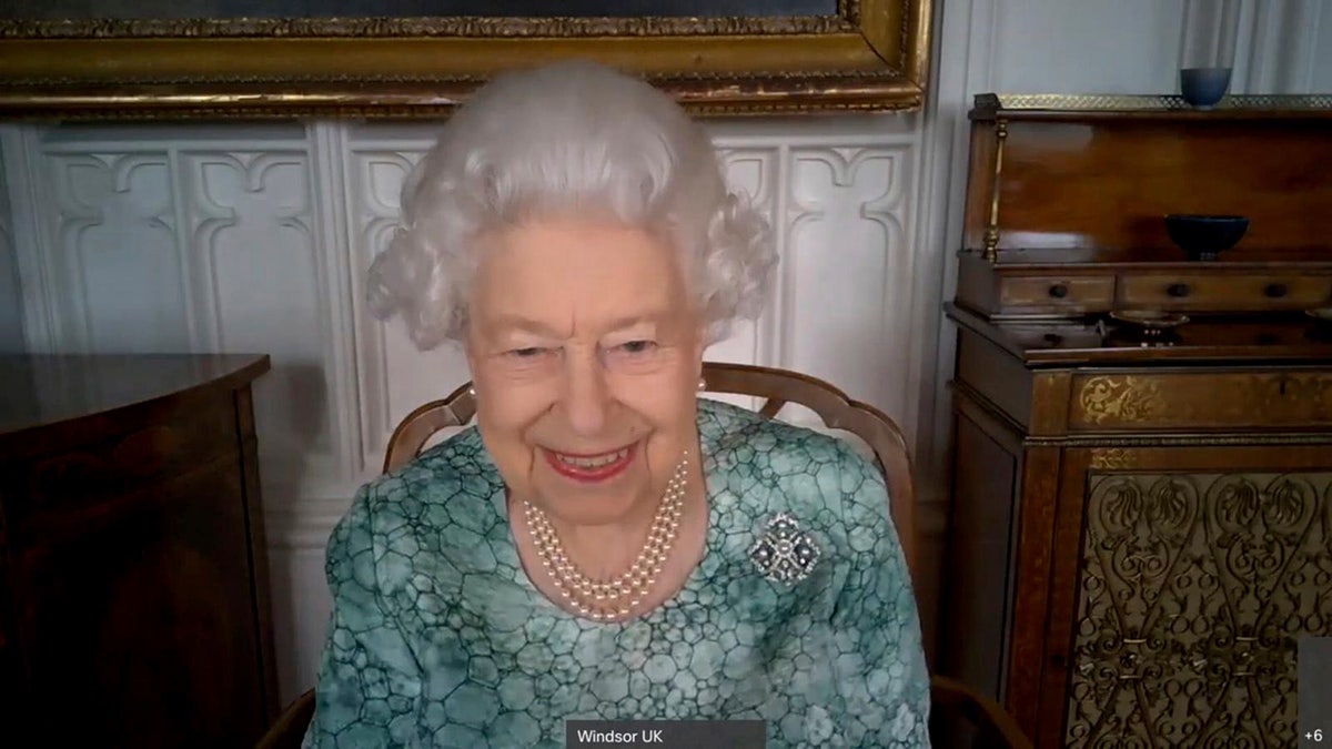 In this undated photo and issued on Friday March 12, 2021 by Buckingham Palace, Britain's Queen Elizabeth II speaks to experts and schoolchildren from Thomas Jones Primary School, West London, in a virtual event to mark British Science Week, showcasing the latest pictures from NASA's mission to Mars and classroom rockets made by the pupils.