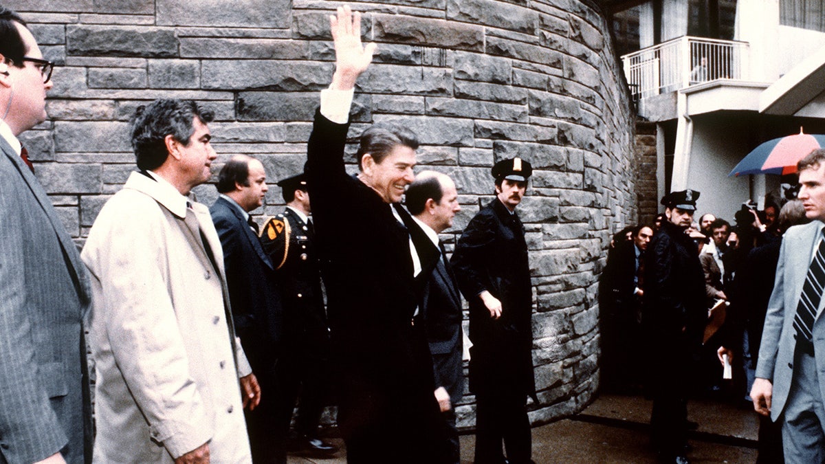 This photo taken by presidential photographer Mike Evens on March 30, 1981 shows President Ronald Reagan waving to the crowd just before the assassination attempt on him, after a conference outside the Hilton Hotel in Washington, D.C.. Reagan was hit by one of six shots fired by John Hinckley, who also seriously injured press secretary James Brady (just behind the car). Reagan was hit in the chest and was hospitalized for 12 days. Hinckley was aquitted 21 June 1982 after a jury found him mentally unstable. 