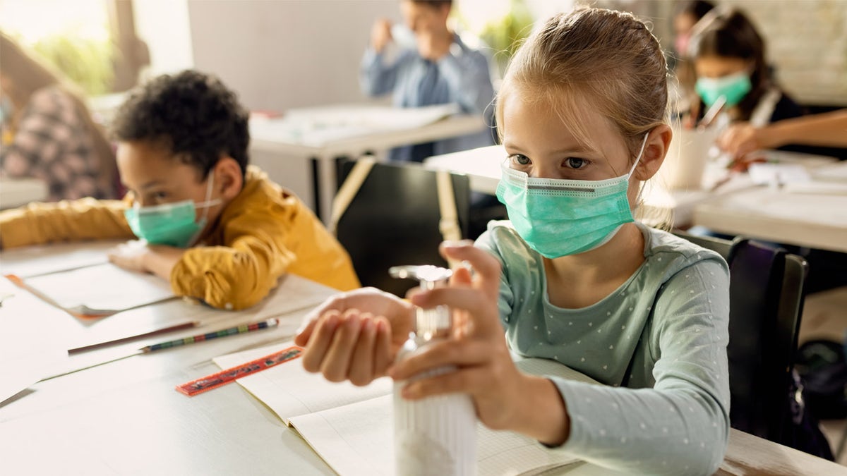 Elementary students wearing masks in the classroom during the COVID pandemic.