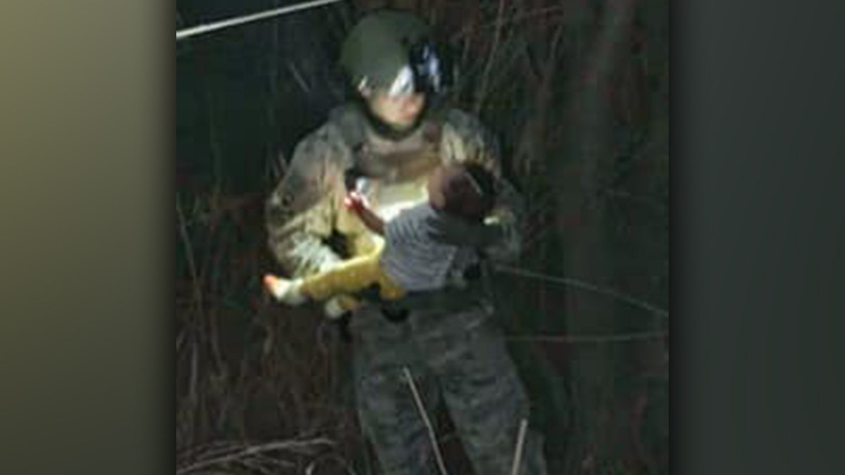 A member of the South Texas Special Operations Group holds a six-month-old baby that was rescued out of the Rio Grande River on March 16.