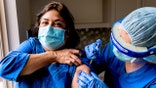 Hispanic Senior mature woman being vaccinated