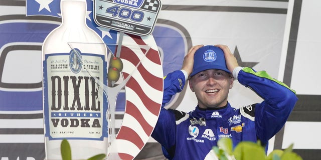 William Byron adjusts his cap as he celebrates after winning a NASCAR Cup Series auto race, Sunday, Feb. 28, 2021, in Homestead, Fla. (AP Photo/Wilfredo Lee)
