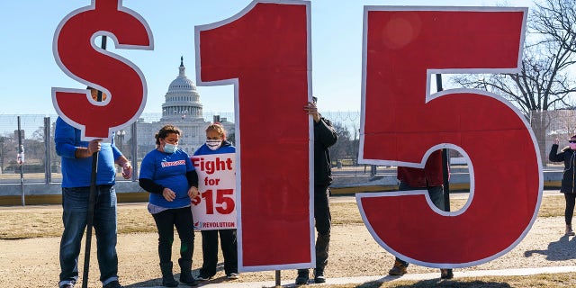 Activists appeal for a $15 minimum wage near the Capitol in Washington.  (AP Photo/J. Scott Applewhite)