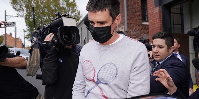 Richard Pusey, the driver of a Porsche who allegedly fled the scene of a truck crash on Melbourne's Eastern Freeway which killed four police officers, is taken away from his Fitzroy property by police in Melbourne, Thursday, April 23, 2020. (AAP Image/Michael Dodge)