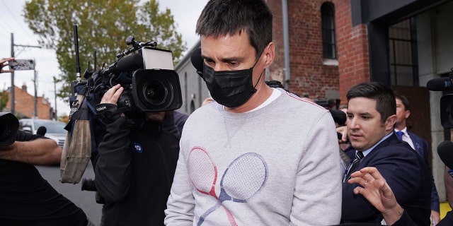 Richard Pusey, the driver of a Porsche who allegedly fled the scene of a truck crash on Melbourne's Eastern Freeway which killed four police officers, is taken away from his Fitzroy property by police in Melbourne, Thursday, April 23, 2020. (AAP Image/Michael Dodge)