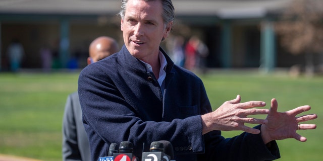 California Gov. Gavin Newsom speaks about the state's plan to reopen schools as coronavirus vaccinations continue during a news conference on the school yard at Barron Park Elementary in Palo Alto, Calif., Tuesday, March 2, 2021. (Karl Mondon/Bay Area News Group via AP)